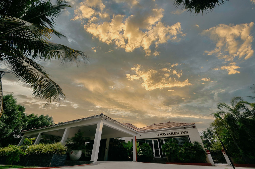 D’Wayfarer Inn entrance at dusk, warmly lit